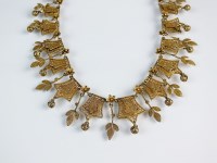Lot 159 - A yellow and white metal filigree fringe...