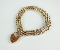 Lot 172 - A yellow metal three bar gate link bracelet,...