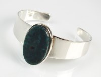 Lot 177 - A bloodstone set torque bangle, the oval...