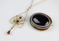 Lot 185 - A garnet and seed pearl openwork pendant,...