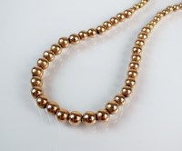 Lot 189 - A yellow metal graduated ball necklace,...