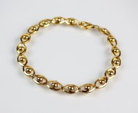 Lot 194 - A decorative yellow metal bracelet, each...