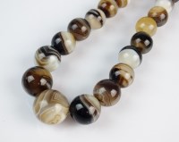 Lot 232 - A graduated banded agate bead necklace,...