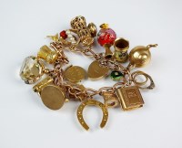Lot 242 - A 9ct gold curb link bracelet with attached...
