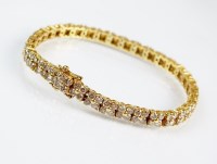 Lot 258 - An 18ct gold diamond set bracelet, designed as...