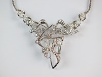 Lot 261 - A diamond set stylised necklace, designed as...