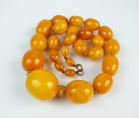 Lot 268 - A graduated amber bead necklace, comprising...