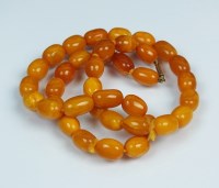 Lot 269 - A uniform amber bead necklace, comprising...