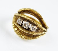 Lot 274 - An 18ct gold three stone diamond ring, the...