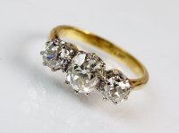 Lot 302 - A three stone graduated diamond ring, designed...