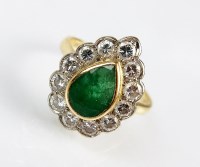 Lot 304 - An emerald and diamond cluster ring, designed...