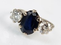 Lot 310 - A three stone diamond and sapphire ring,...