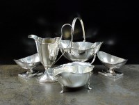 Lot 5 - A silver swing handled sugar bowl and helmet...
