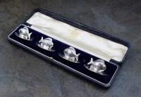 Lot 15 - An Edwardian cased set of four silver place...