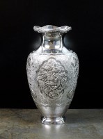Lot 30 - A white metal baluster vase, with chased and...