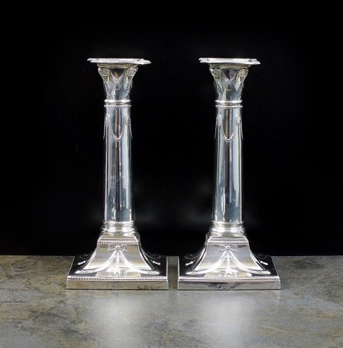 Lot 37 - A pair of Edwardian silver candlesticks,...