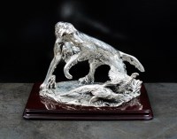 Lot 50 - A white metal model of a hunting dog with...