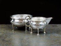 Lot 89 - A hammered silver sugar bowl and cream jug,...