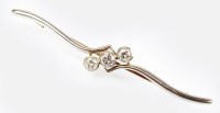 Lot 148 - A three stone diamond set bar brooch, designed...