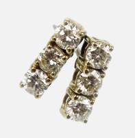 Lot 180 - A pair of diamond three stone earrings, each...