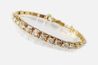 Lot 220 - A graduated diamond bracelet, designed as a...