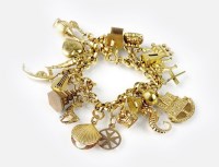 Lot 254 - A circular link bracelet with attached charms,...