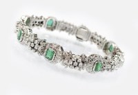 Lot 256 - An emerald and diamond bracelet, designed as...