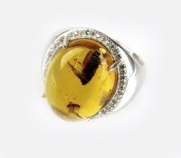 Lot 263 - A cabochon Burmese amber dress ring, the amber...