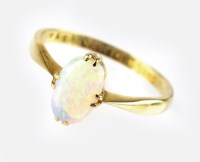 Lot 300 - An 18ct gold opal dress ring, designed as a...