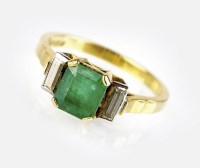 Lot 306 - An 18ct gold three stone emerald and diamond...