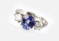 Lot 307 - An 18ct white gold three stone sapphire and...