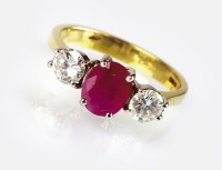 Lot 313 - An 18ct gold three stone ruby and diamond ring,...