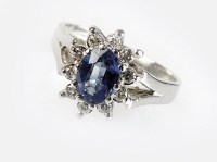 Lot 326 - A platinum sapphire and diamond cluster ring,...