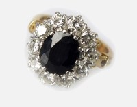 Lot 337 - A sapphire and diamond cluster ring, designed...