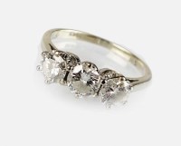 Lot 339 - An 18ct white gold three stone diamond ring,...