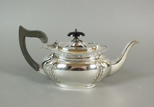 Lot 34 - An Edwardian bachelors silver teapot, makers...