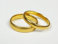 Lot 57 - Two plain polished 22ct gold wedding bands,...