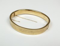 Lot 138 - A 9ct gold hallow hinged bangle, with attached...