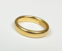 Lot 143 - A plain polished yellow metal wedding band,...