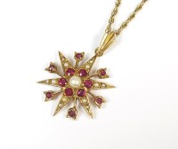 Lot 149 - A 9ct gold seed pearl and ruby pendant, the...