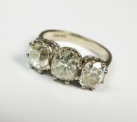 Lot 158 - An 18ct white gold three stone diamond ring,...