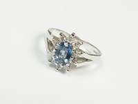 Lot 174 - A platinum sapphire and diamond cluster ring,...