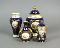 Lot 280 - Four Coalport cobalt and gilt landscape vases...