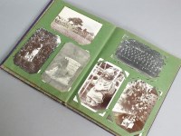 Lot 423 - An album of postcards and photographs, circa...