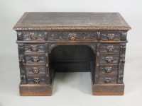 Lot 594 - A Victorian carved oak knee hole pedestal desk,...