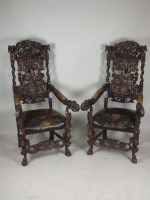 Lot 597 - A monumental pair of Victorian carved oak hall...