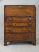 Lot 622 - A George III crossbanded oak bureau, the...