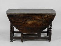 Lot 94 - A late 17th century oak gate leg dining table...