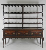 Lot 120 - A George III oak three drawer dresser base on...