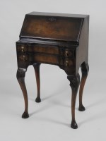 Lot 135 - A early 20th century walnut veneered...